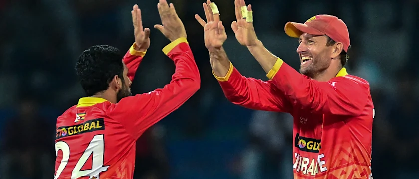 Cricket players from Zimbabwe and Sri Lanka teams competing in T20 match at Harare Sports Club with spectators